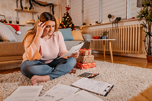 upset woman stressing over holiday debt