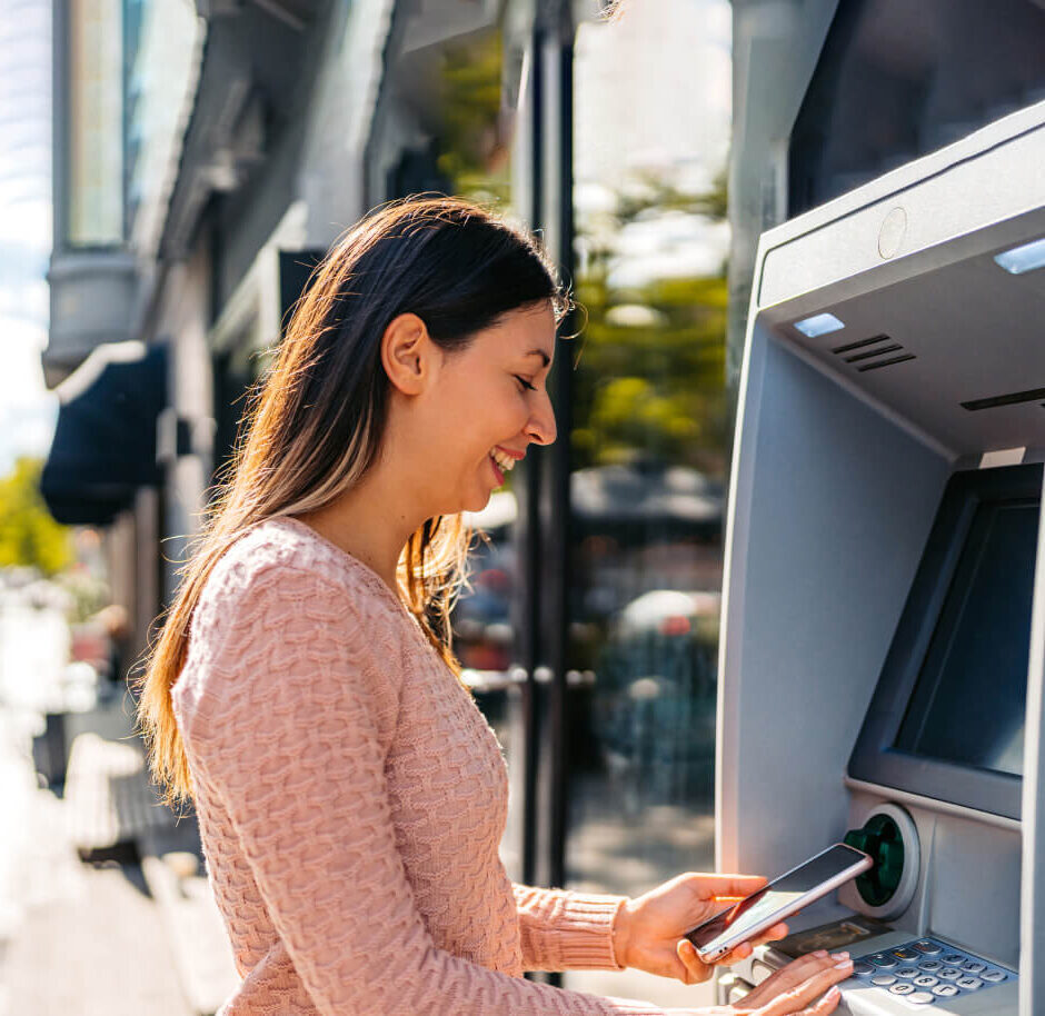 Woman using atm machine