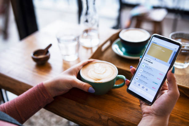 A person holding a smartphone displaying a finance app.