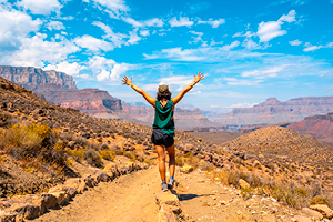 A person stands on a desert trail.