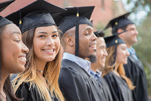 A group of smiling graduates poses together.