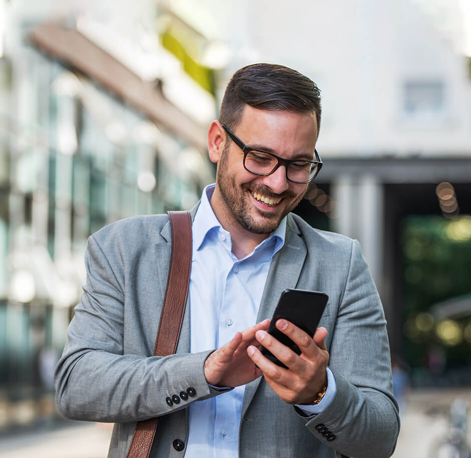 happy-man-using-mobile-to-check-rates