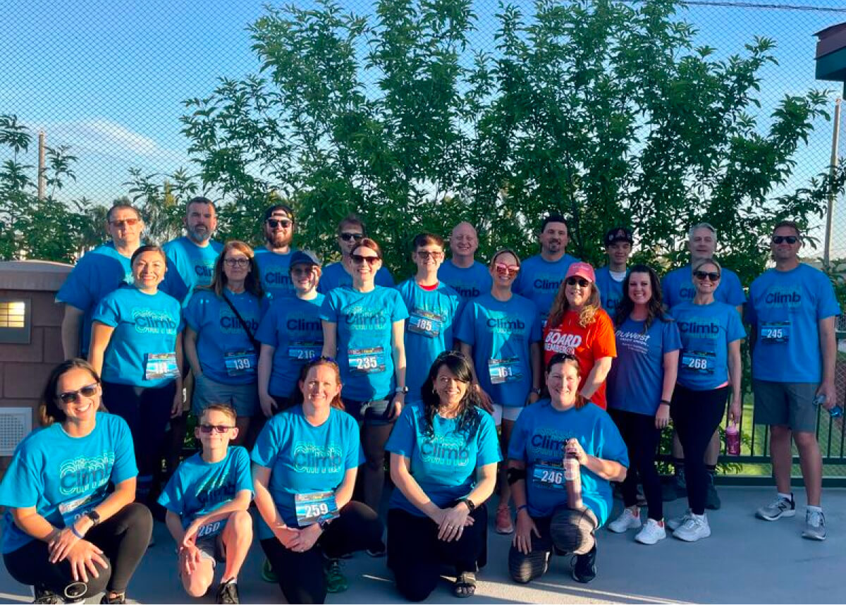 A group of people in matching blue t-shirts.