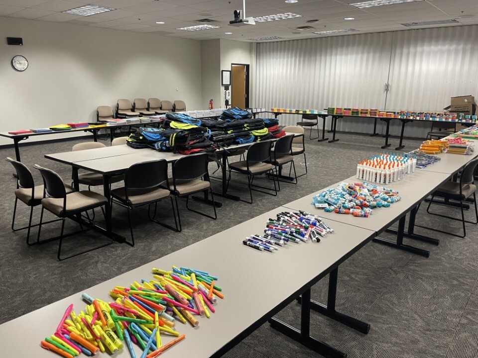 classroom with school supplies laid out on tables