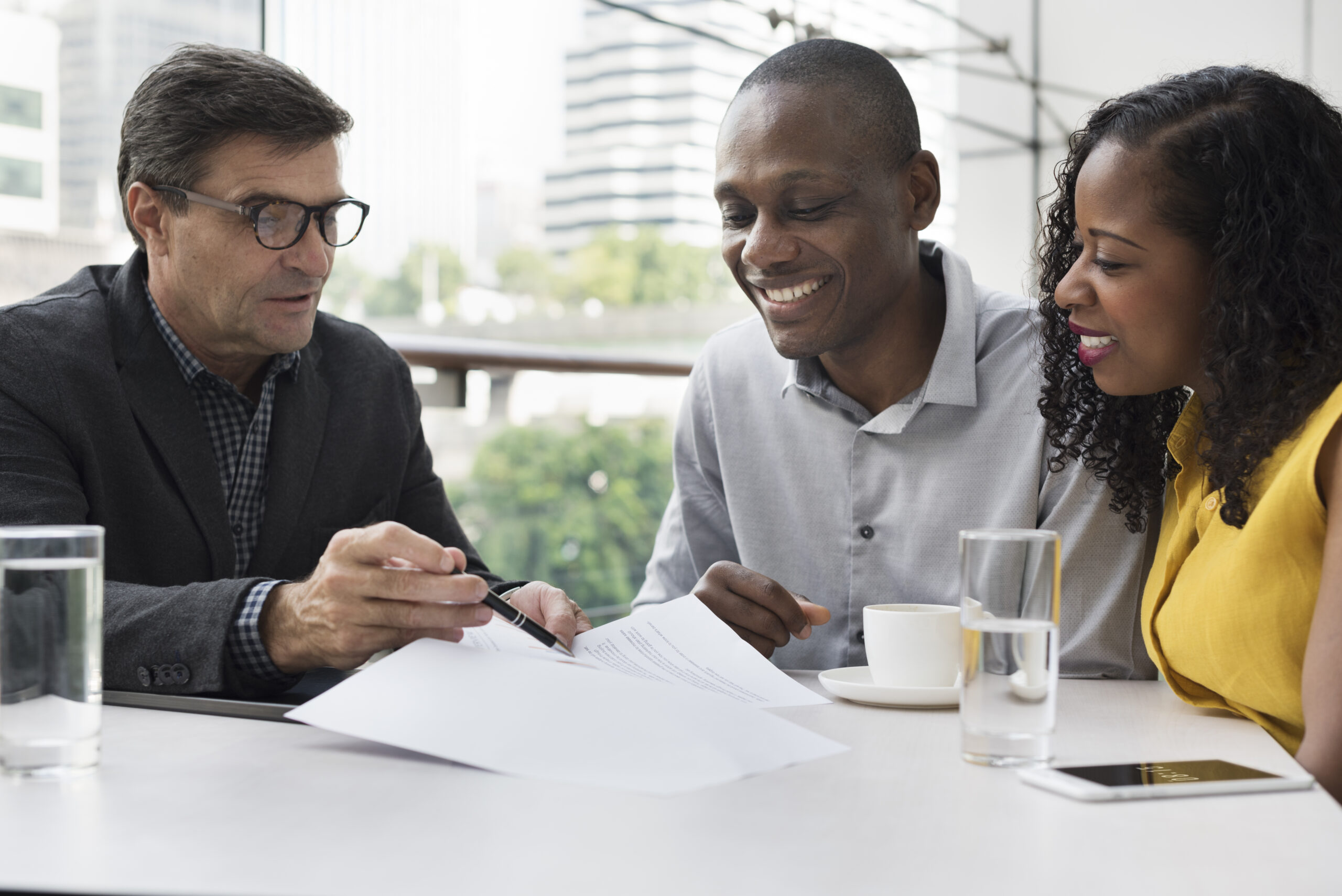 a couple smiling while talking to a lender