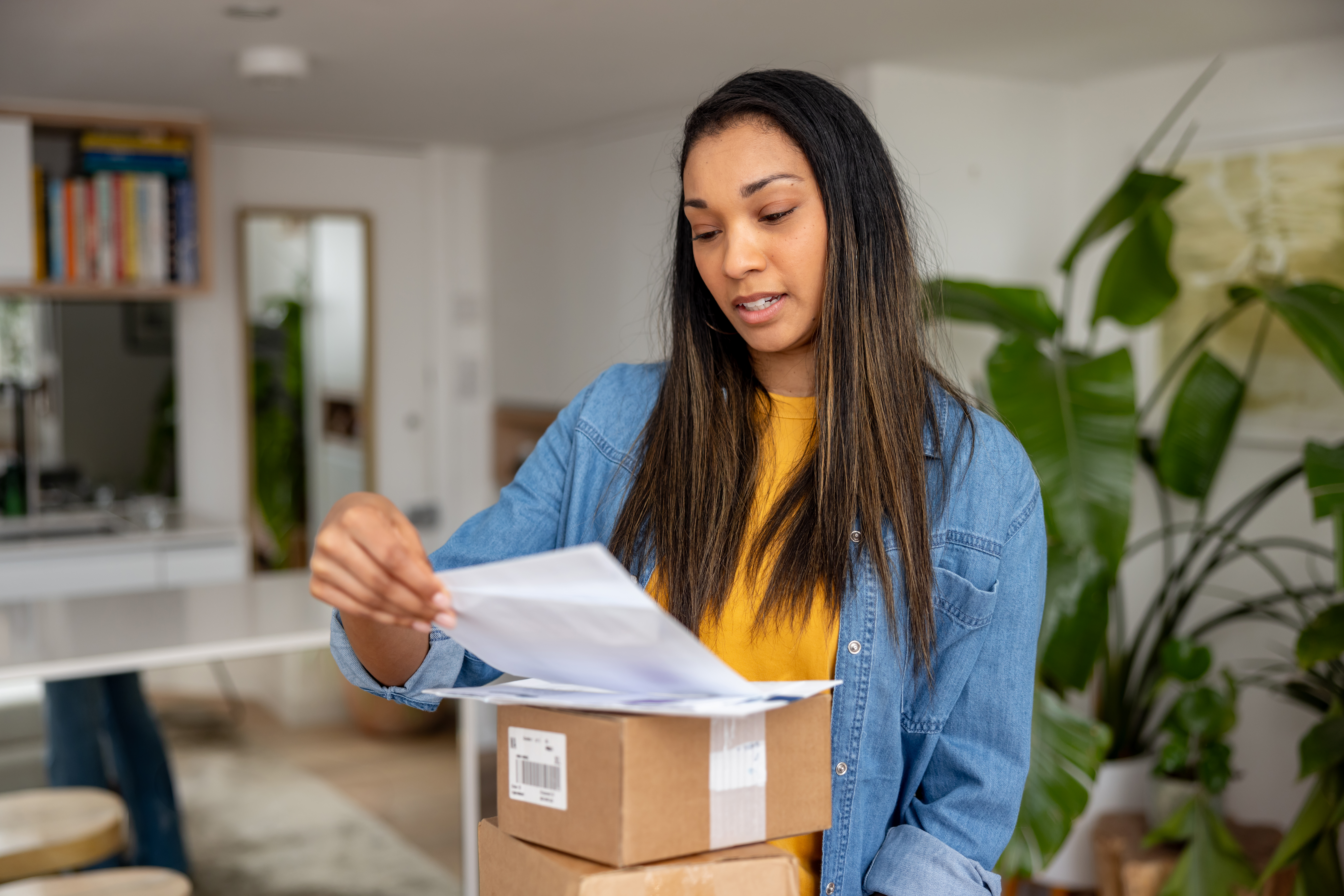 woman at home looking at her mail